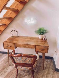 a wooden desk with a potted plant on top of it at Unique Condo on flight park! Watch hangliders fly! in Wildwood