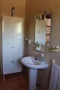 a bathroom with a white sink and a mirror at Casa El Calderon in Chella