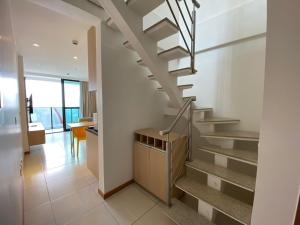 a staircase in a home with white walls at HOSPEDE-SE JÁ DUPLEX in Brasilia