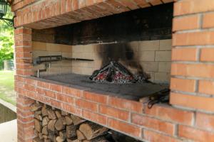 a brick oven with a fire in it at VILA HELENA in Velenje