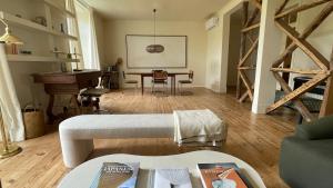 a living room with a table and a piano at Eco Luxury apartment LISBOA-Campo de Ourique in Lisbon