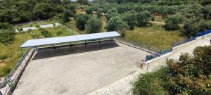 an empty parking lot with a white roof at Villa Rodanthi Sivota in Syvota