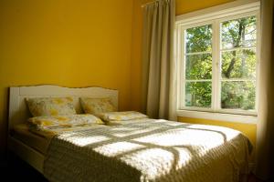 a bedroom with a bed in front of a window at Lovely nest in Nõmme in Tallinn