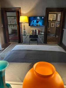 1 dormitorio con 1 cama y TV en una habitación en Castellata La Suite, en Bolonia