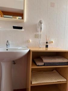 a bathroom with a sink and a white sink at Monterovere in Albergo Monte Rovere