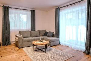 a living room with a couch and a table at Apartmány Belá in Spišská Belá