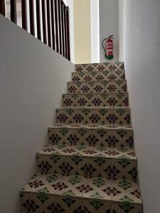 a stairwell with a tile floor and a stair case with a carpet at Villa Vintage Dulcinea in Camuñas