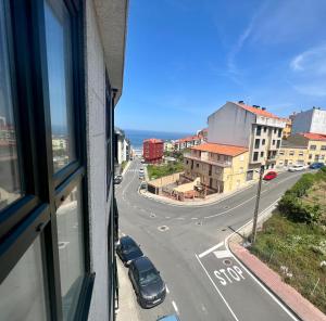 una ventana con vistas a una calle de la ciudad en Öspede Surf And Montain Malpica de Bergantiños-Costa da Morte, en Malpica de Bergantiños