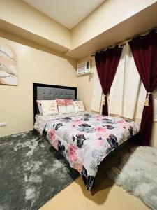 a bedroom with a bed with a floral comforter at * *K Irresistable value for 3 in Iloilo City