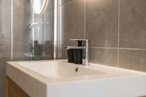 a bathroom sink with a faucet on top of it at Splendide et idéalement situé proche du palais. in Cannes