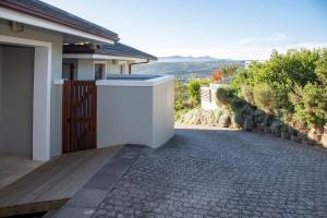 a house with a walkway leading to a driveway at Sunset Haven in Knysna