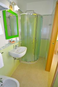a bathroom with a glass shower and a sink at B&B Lu Cantoru in Marina di Pescoluse