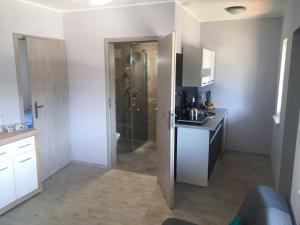 a kitchen with a sink and a shower in a room at Lazurowy Zakątek in Dąbki +10 photos