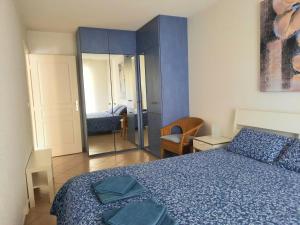una camera con letto blu e specchio di Appartement Marseille Vacances a Marsiglia