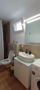 a bathroom with a white sink and a toilet at NOCE Luxury Villas Resort in Vourvourou +242 photos
