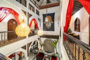 a staircase in a house with chandeliers at Riad Balkisse in Marrakesh