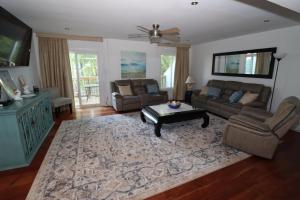 a living room with a couch and a coffee table at Cheerful Beach Townhouse in Virginia Beach