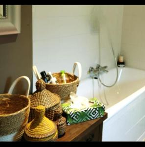 a bathroom with baskets on a counter next to a tub at La Constance 