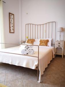 a bedroom with a large bed with towels on it at Harmony by the sea - 20 meters from the sea in Kaloi Limenes