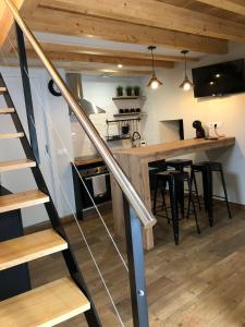 a kitchen and dining room with a staircase in a house at Apartamentos El Arroyo in Armal