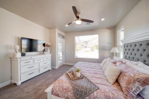 a bedroom with a large bed and a flat screen tv at New South Zion Coral Cliffs - 4 bed, 3 bath, hot tub, deck in Hildale