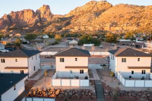 an aerial view of a village with mountains in the background at New South Zion Coral Cliffs - 4 bed, 3 bath, hot tub, deck in Hildale