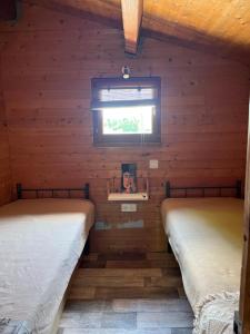 Llit o llits en una habitació de les petits chalets de DUDU