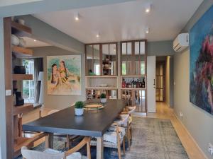 a dining room with a table and chairs at EXQUISITE GOLF VILLA with Sea, 8Tee, Green Views, in Aphrodite Hills Golf Resort in Kouklia