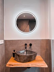 a bathroom with a stone sink and a mirror at Wohlfühlapartment Nähe Legoland mit Terrasse in Günzburg +31 photos