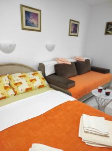 a living room with two beds and a couch at Apartmani CECA 012 Sutomore in Sutomore