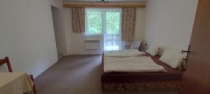 a room with two beds and a window at Penzion Svojanov in Svojanov