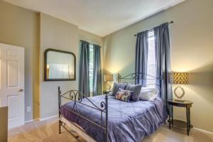 a bedroom with a bed and a mirror at St Louis Vacation Rental about 2 Mi to Downtown in Soulard