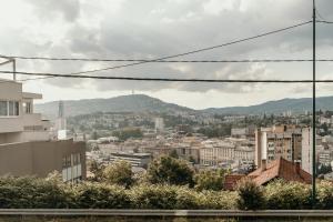 a view of a city with mountains in the background at Sarajevo Central View Apartment in Sarajevo