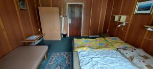 a small bedroom with a bed and a table at Penzion Svojanov in Svojanov