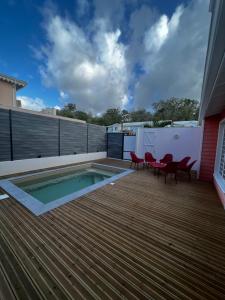 a deck with a swimming pool on a house at Villa Timoun - Standing - 3 ch in Quartiers Anse à lʼÂne