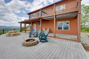 a house with a deck with chairs and a fire pit at Blue Ridge Mountain Cabin with Views, 2 Mi to Dtwn! in Murphy