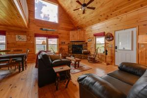 a living room with leather furniture and a fireplace at Blue Ridge Mountain Cabin with Views, 2 Mi to Dtwn! in Murphy
