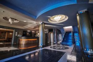 eine Lobby mit blauer Decke und einer Treppe in der Unterkunft Hotel Uzhgorod in Uschhorod