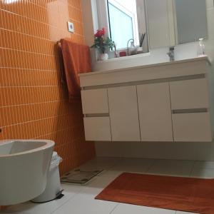 a bathroom with a sink and a toilet at ÍSIS Guest House in Braga