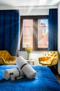 a bedroom with a bed with a stuffed animal on it at Grelewicz Apartments-MyView in Toruń