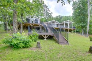 a large house in the middle of a forest at Lakefront Arkansas Home with Dock and Sunroom in Hot Springs