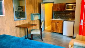a small kitchen with a table and a counter top at Crestwood Motel in Burlington