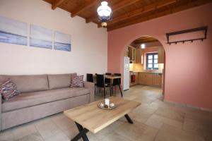 a living room with a couch and a table at Hytra view house in Kythira