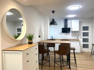 a kitchen with a table and chairs and a mirror at CENTRO GIJON CABRALES 31 in Gijón