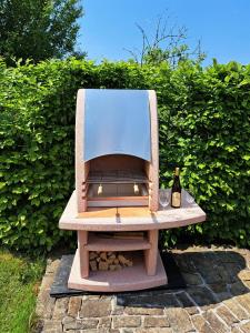 a wooden bench with a bottle of wine on it at Apartmány Hutisko 769 in Hutisko +163 photos