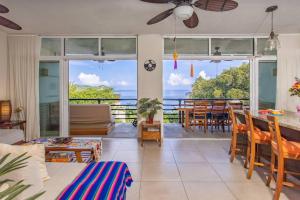 a living room with a view of the ocean at Vista al Mar - Monterosa in Sayulita