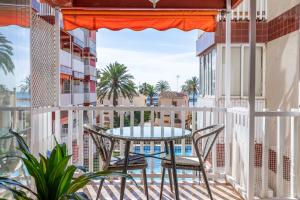 a patio with a table and chairs on a balcony at Apartamento Pobla de farnals, vistas al mar, wifi in Puebla de Farnals