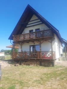 Una casa grande con una terraza en el lateral. en Mazurska Sielanka, en Orzysz