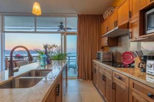 a kitchen with a large window with a view of the ocean at Skyhouse in Sayulita