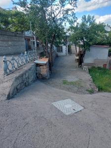 a stone path with a bench and a table at Hotel Rabat Castle in Akhaltsikhe